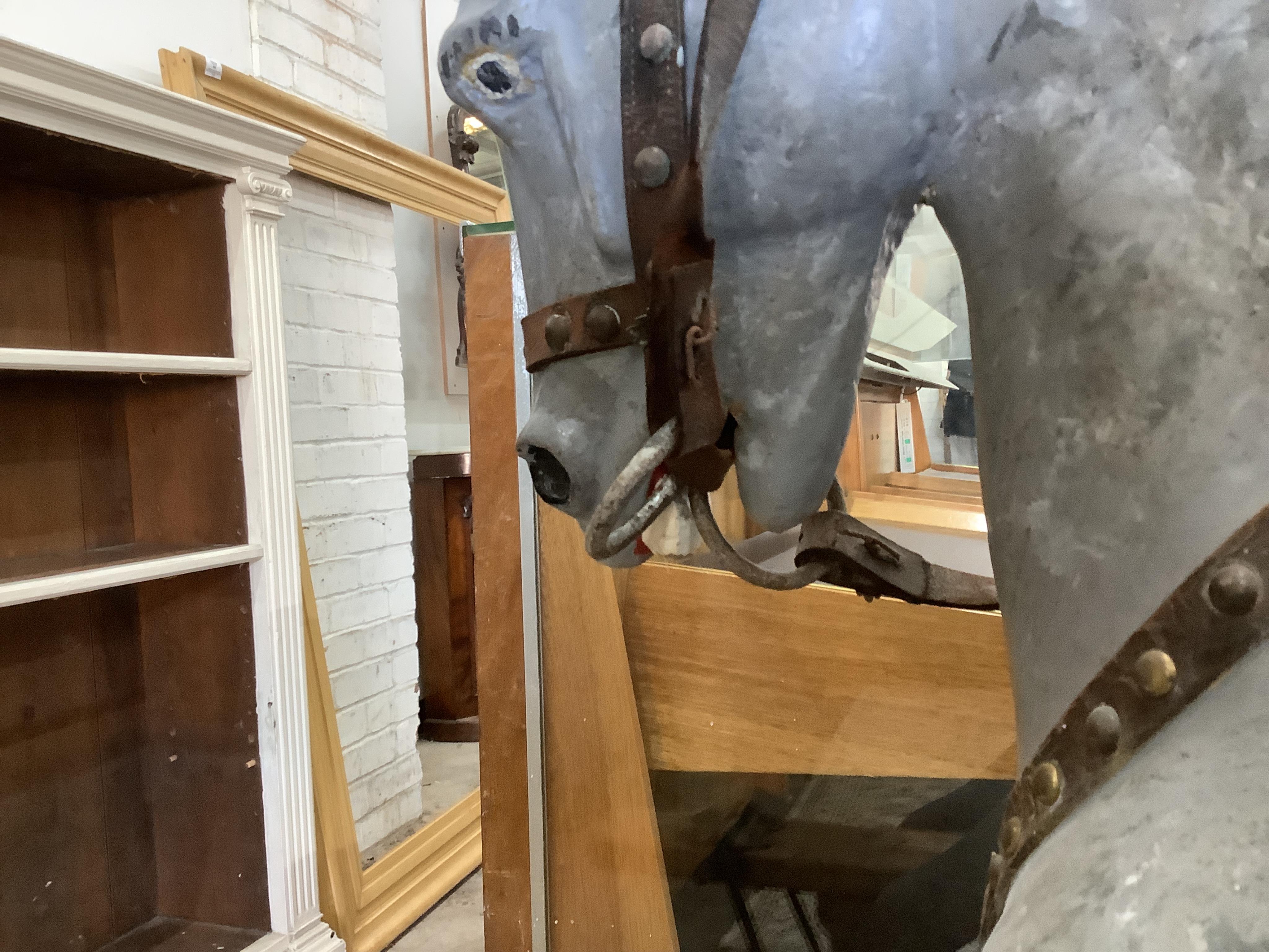 An early 20th century dapple grey rocking horse on pine safety frame, length 136cm, height 108cm. Condition - fair, later painted